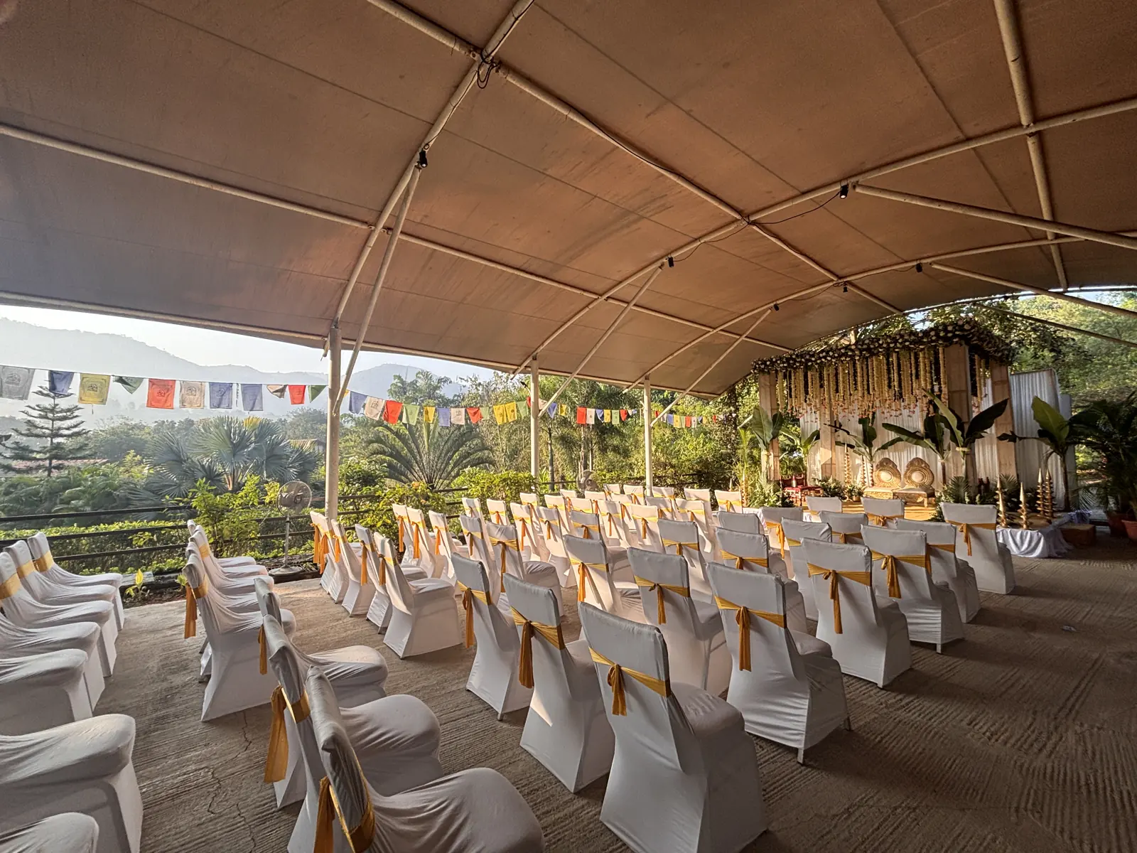 Chairs set for a ceremony under the covered pavilion