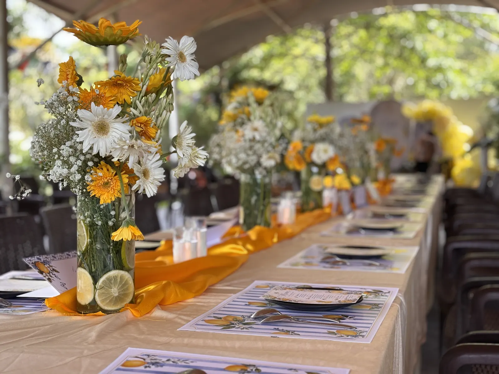 Dining tables set with sunflowers and daisies