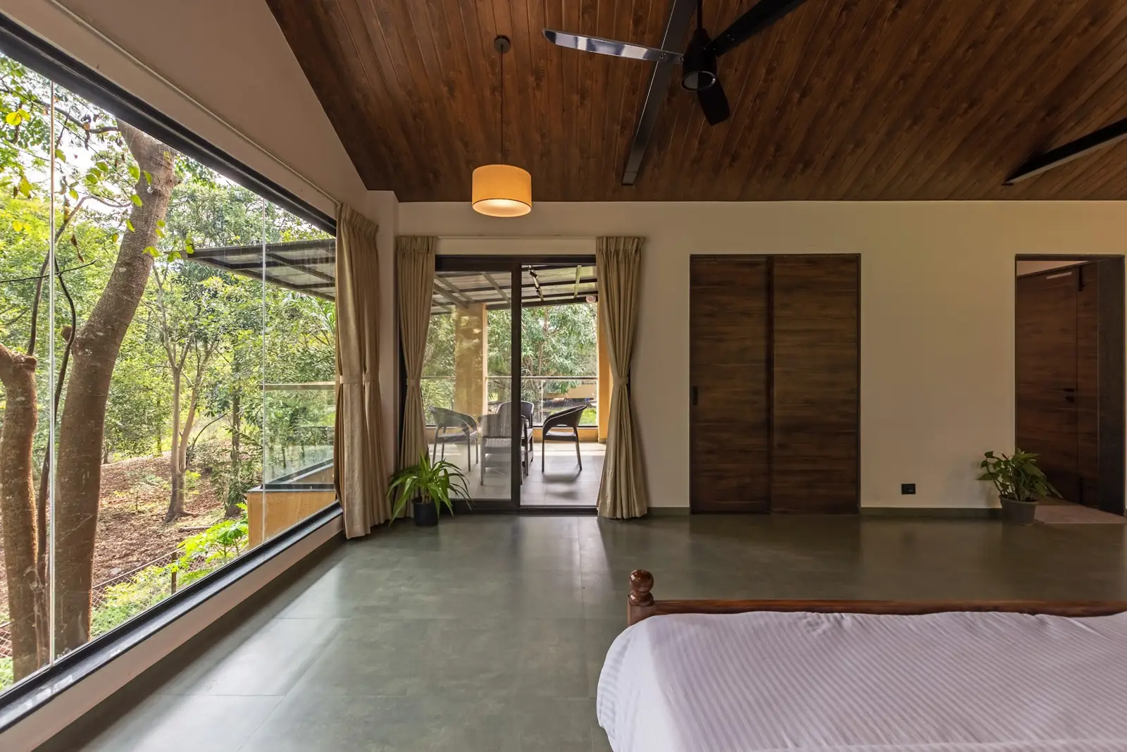 Riverside Suite with a full glass wall onto the trees